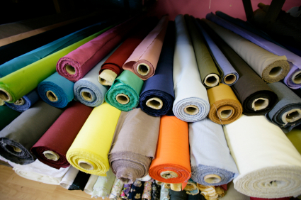 Rolls of brightly coloured fabrics and cloths in a London market. Canon 1Ds Mark 2 file